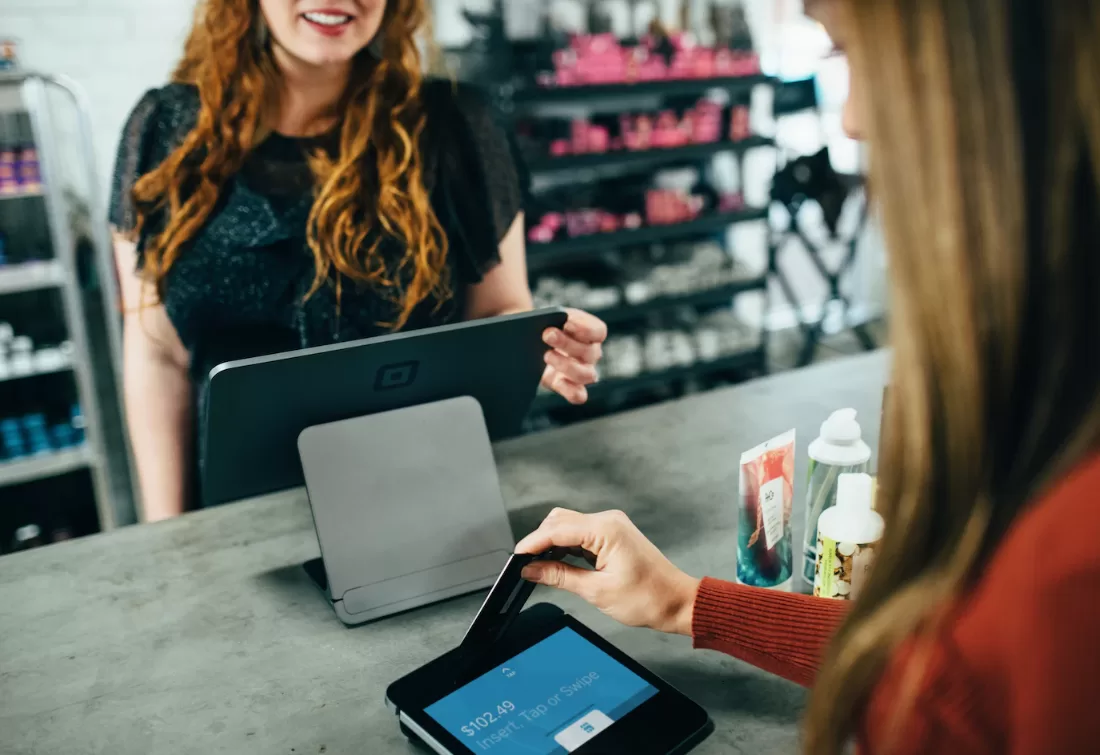 A woman at a store's checkout desk 