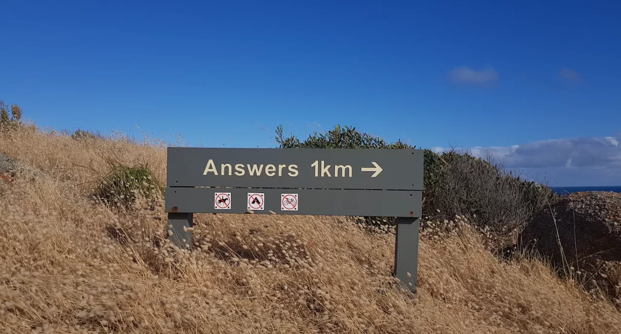 A funny sign on the side of a hill