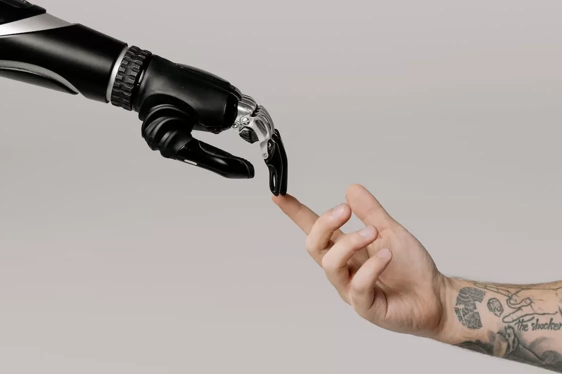 A Creation of Adam painting-inspire photo with a human arm holding finger with a robotic arm