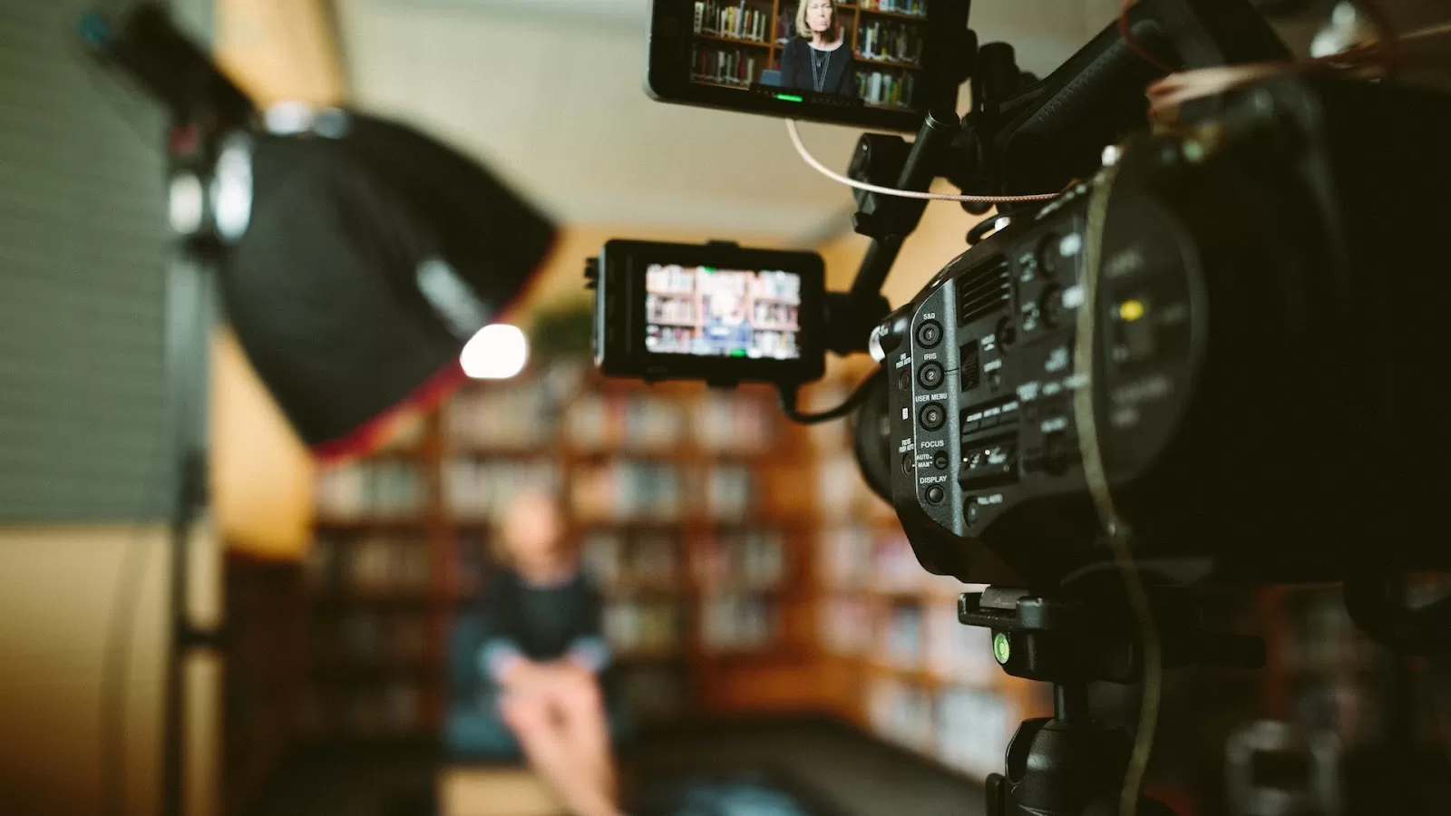 A camera recording a person at a library