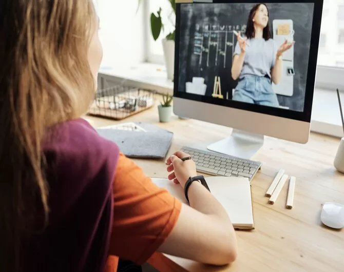 A woman watching a video with another woman talking