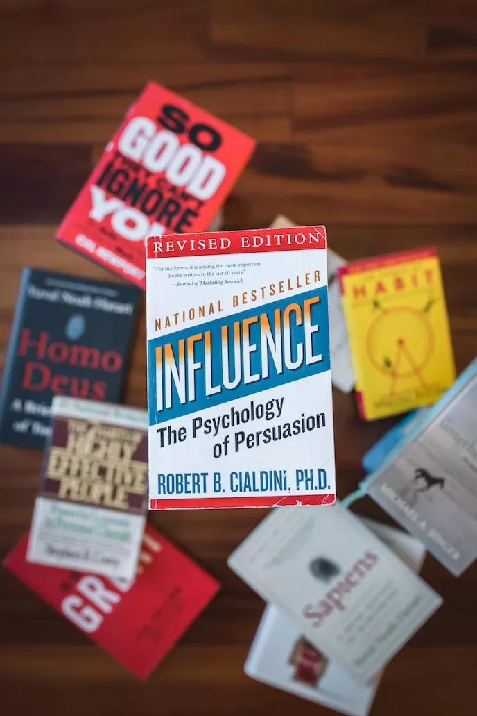 Several books with the top one having the title Influence