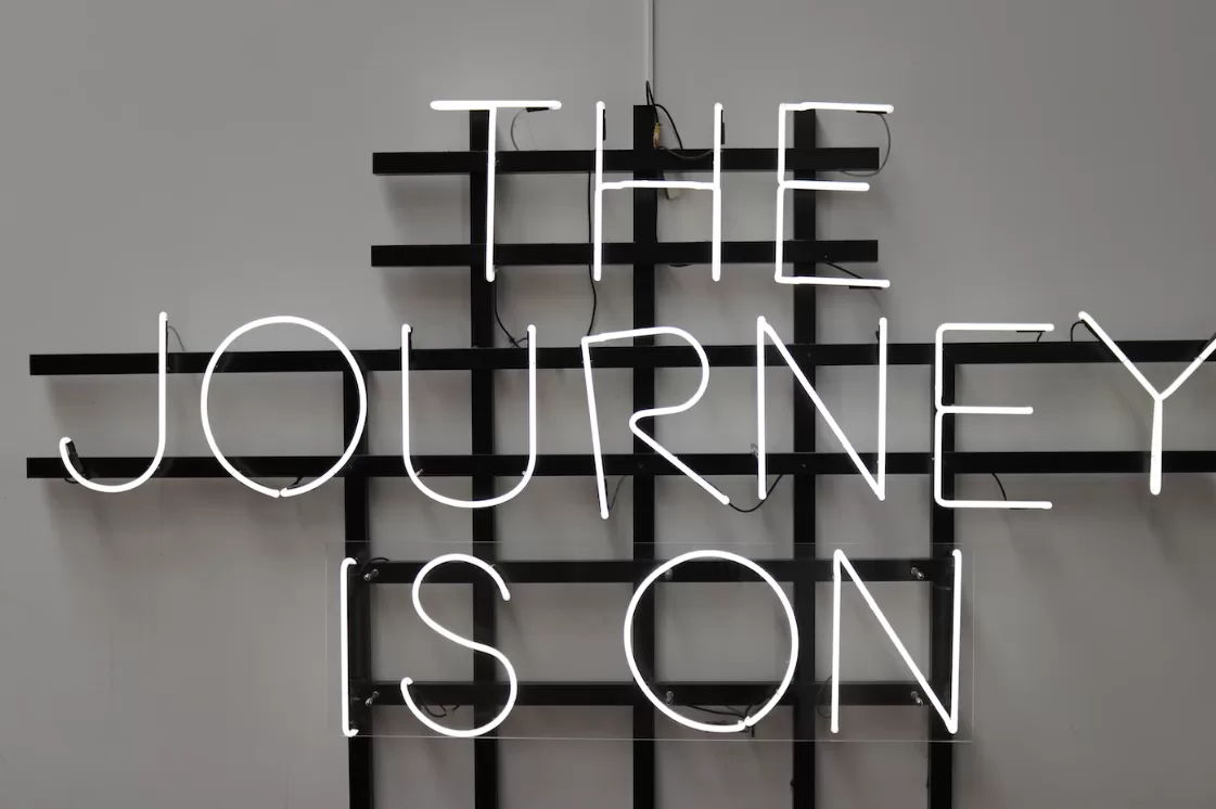 A neon sign The Journey is On